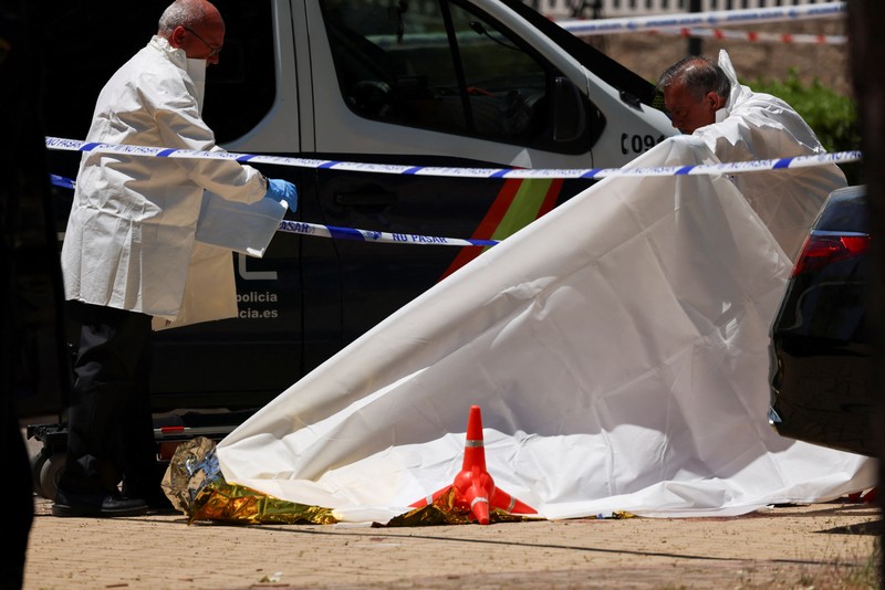 SPAIN-MURDER/UKRAINE Members of the forensic team work at the spot where former Ukrainian politician Andriy Portnov, according to the Spain's Interior Ministry, was shot by unidentified gunmen, outside a school in a wealthy suburb of Madrid, in Madrid, Spain May 21, 2025. REUTERS/Nacho Doce