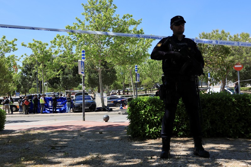 Members of the forensic team work at the spot where former Ukrainian politician Andriy Portnov, according to the Spain's Interior Ministry, was shot by unidentified gunmen, outside a school in a wealthy suburb of Madrid, in Madrid, Spain May 21, 2025. REUTERS/Nacho Doce