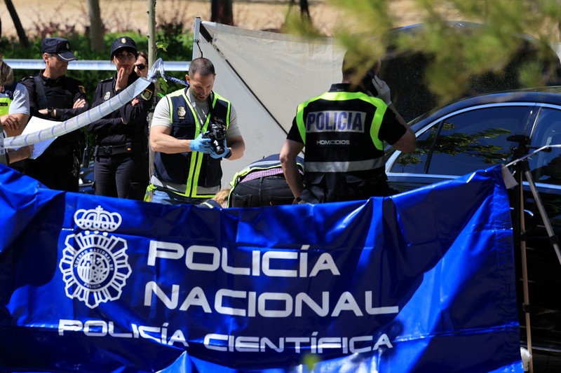SPAIN-MURDER/UKRAINE Members of the forensic team work at the spot where former Ukrainian politician Andriy Portnov, according to the Spain's Interior Ministry, was shot by unidentified gunmen, outside a school in a wealthy suburb of Madrid, in Madrid, Spain May 21, 2025. REUTERS/Nacho Doce