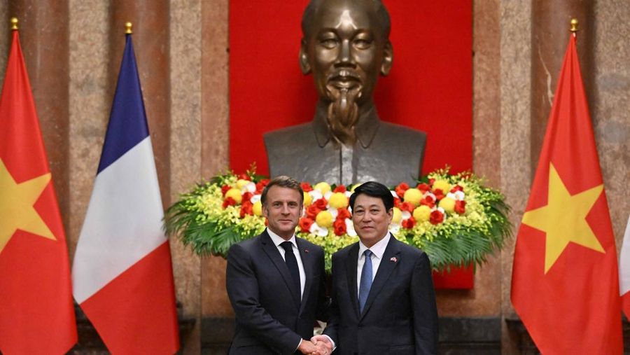 France's President Emmanuel Macron and Vietnam's President Luong Cuong shake hands during a meeting at the Presidential Palace in Hanoi on May 26, 2025.     NHAC NGUYEN/Pool via REUTERS