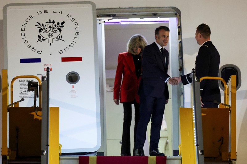 French President Emmanuel Macron stands near the door of a plane, as a hand appears and pushes his face away, in Hanoi, Vietnam, May 25, 2025, in this screengrab from a video. Reuters TV/via REUTERS