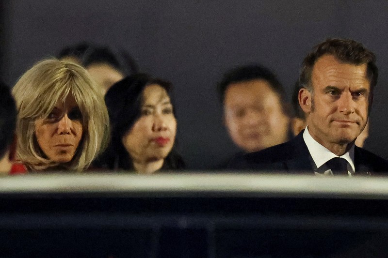 French President Emmanuel Macron stands near the door of a plane, as a hand appears and pushes his face away, in Hanoi, Vietnam, May 25, 2025, in this screengrab from a video. Reuters TV/via REUTERS