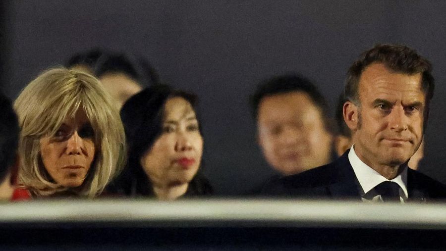 French President Emmanuel Macron stands near the door of a plane, as a hand appears and pushes his face away, in Hanoi, Vietnam, May 25, 2025, in this screengrab from a video. Reuters TV/via REUTERS