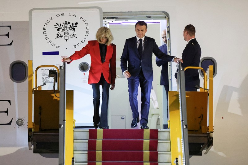 French President Emmanuel Macron stands near the door of a plane, as a hand appears and pushes his face away, in Hanoi, Vietnam, May 25, 2025, in this screengrab from a video. Reuters TV/via REUTERS