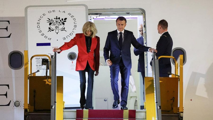 France's President Emmanuel Macron and his wife Brigitte Macron arrive at Noi Bai International Airport, marking the first trip to Vietnam by a French president in nearly a decade, in Hanoi, Vietnam, May 25, 2025. REUTERS/Chalinee Thirasupa