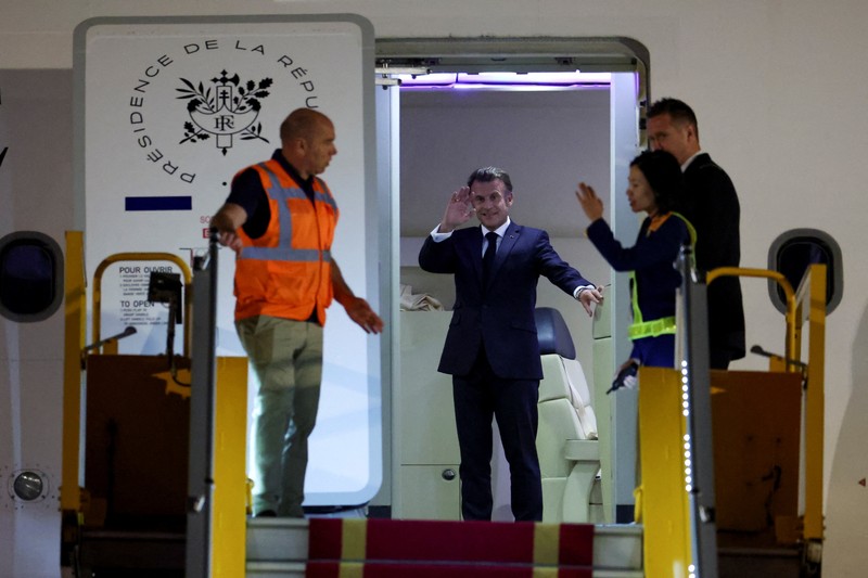 French President Emmanuel Macron stands near the door of a plane, as a hand appears and pushes his face away, in Hanoi, Vietnam, May 25, 2025, in this screengrab from a video. Reuters TV/via REUTERS