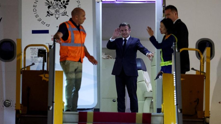 VIETNAM-FRANCE/MACRON-WIFE French President Emmanuel Macron stands near the door of a plane, as a hand appears and pushes his face away, in Hanoi, Vietnam, May 25, 2025, in this screengrab from a video. Reuters TV/via REUTERS