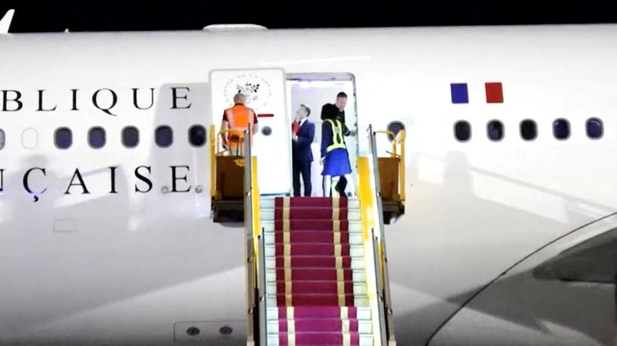 VIETNAM-FRANCE/MACRON-WIFE French President Emmanuel Macron stands near the door of a plane, as a hand appears and pushes his face away, in Hanoi, Vietnam, May 25, 2025, in this screengrab from a video. Reuters TV/via REUTERS
