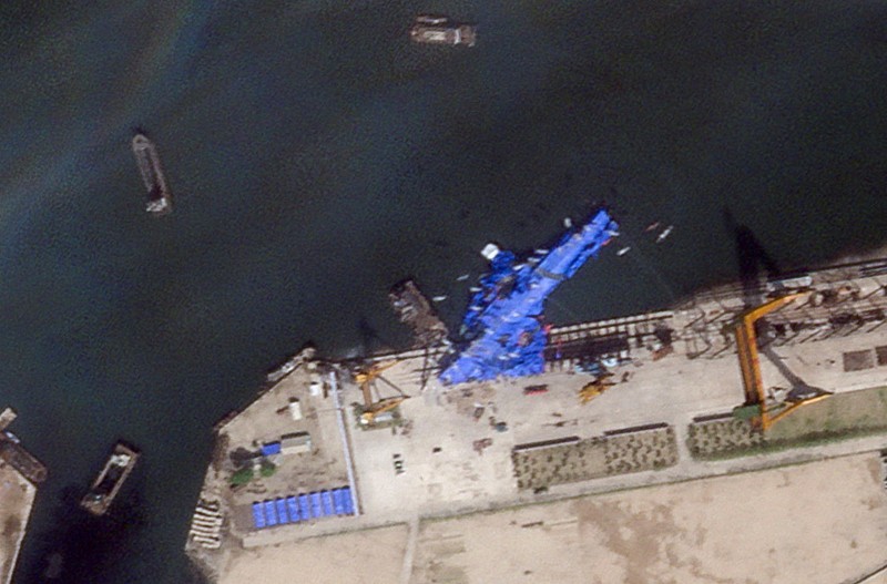 A satellite image shows a North Korean warship covered with a blue tarp after an accident that occurred during its launch at the shipyard, in Chongjin, North Korea, May 23, 2025. Maxar Technologies /Handout via REUTERS THIS IMAGE HAS BEEN SUPPLIED BY A THIRD PARTY. NO RESALES. NO ARCHIVES. MANDATORY CREDIT. MUST NOT OBSCURE LOGO.
