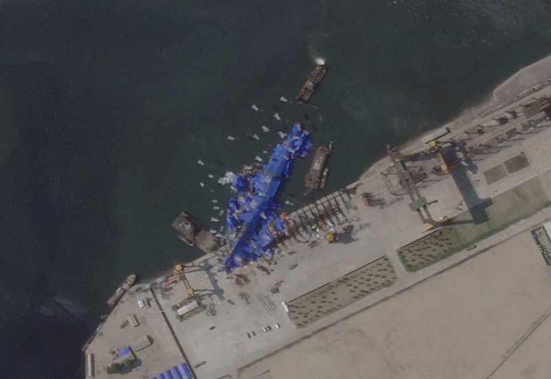 A satellite image shows a North Korean warship covered with a blue tarp after an accident that occurred during its launch at the shipyard, in Chongjin, North Korea, May 23, 2025. Maxar Technologies /Handout via REUTERS THIS IMAGE HAS BEEN SUPPLIED BY A THIRD PARTY. NO RESALES. NO ARCHIVES. MANDATORY CREDIT. MUST NOT OBSCURE LOGO.