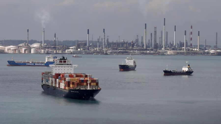 Sebuah kapal kontainer melewati kilang Shell di Pulau Bukom di Singapura pada 17 November 2020. REUTERS/Edgar Su/Foto Arsip/Foto Arsip