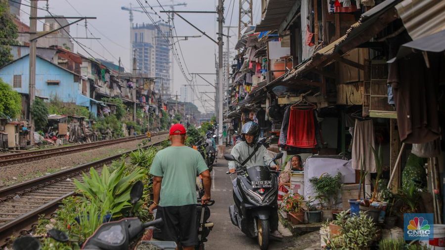 Suasana aktivitas warga pada permukiman kumuh yang berdekatan dengan rel kereta di Jakarta, Senin (2/6/2025). (CNBC Indonesia/Faisal Rahman)