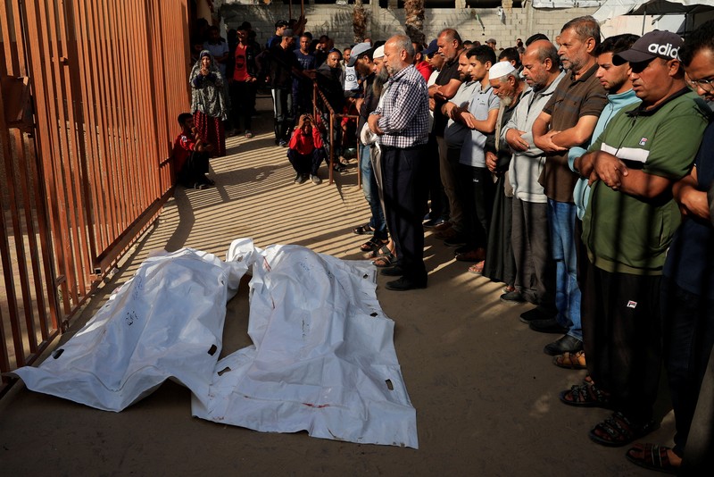 ISRAEL-PALESTINIANS/GAZA Mourners pray near the bodies of Palestinians killed, in what the Gaza health ministry say was Israeli fire near a distribution site in Rafah, at Nasser hospital in Khan Younis, in the southern Gaza Strip, June 3, 2025. REUTERS/Hatem Khaled