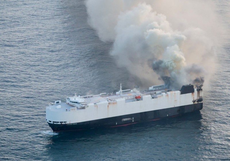 Smoke rises from a fire aboard the cargo vessel Morning Midas, carrying around 3,000 vehicles, including 800 electric vehicles, as seen in an aerial photograph taken from a U.S. Coast Guard C-130J Super Hercules, approximately 300 miles south of Adak, Alaska, U.S. June 3, 2025.  U.S. Coast Guard/Air Station Kodiak/Handout via REUTERS.  THIS IMAGE HAS BEEN SUPPLIED BY A THIRD PARTY
