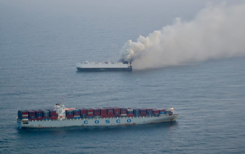 Smoke rises from a fire aboard the cargo vessel Morning Midas, carrying around 3,000 vehicles, including 800 electric vehicles, as seen in an aerial photograph taken from a U.S. Coast Guard C-130J Super Hercules, approximately 300 miles south of Adak, Alaska, U.S. June 3, 2025.  U.S. Coast Guard/Air Station Kodiak/Handout via REUTERS.  THIS IMAGE HAS BEEN SUPPLIED BY A THIRD PARTY