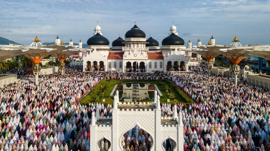 Foto udara menunjukkan jamaah Muslim melaksanakan salat Idul Adha di Masjid Raya Baiturrahman, Banda Aceh, Jumat (6/6/2025). (CHAIDEER MAHYUDDIN / AFP)