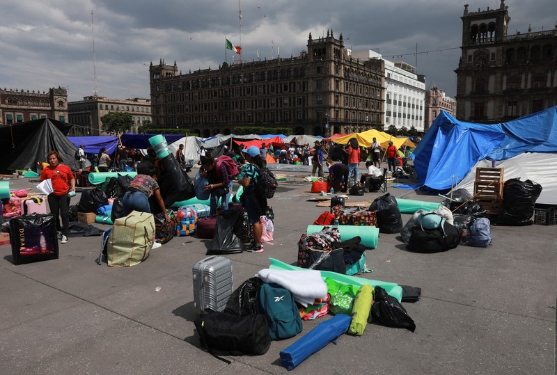 MEXICO-PROTEST/TEACHERS People remove their belongings, tents and tarps set up by members of the National Coordination of Education Workers (CNTE) at the site of a protest to demand dialogue with the government regarding their labor and educational demands, at Zocalo square, in Mexico City, Mexico June 6, 2025. REUTERS/Henry Romero