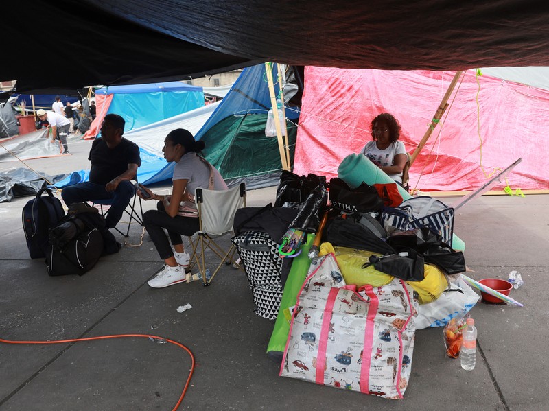 MEXICO-PROTEST/TEACHERS People remove their belongings, tents and tarps set up by members of the National Coordination of Education Workers (CNTE) at the site of a protest to demand dialogue with the government regarding their labor and educational demands, at Zocalo square, in Mexico City, Mexico June 6, 2025. REUTERS/Henry Romero