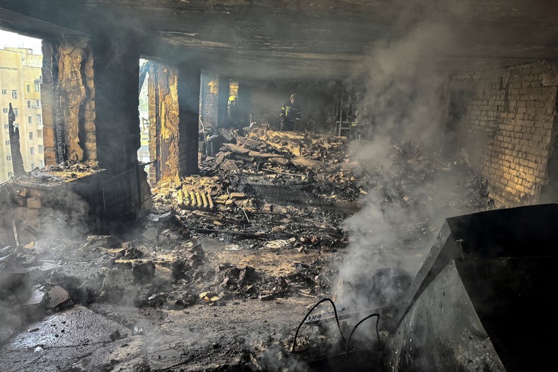 UKRAINE-CRISIS/ATTACK-KHARKIV Firefighters work at the site of a building hit by a Russian drone strike, amid Russia's attack on Ukraine, in Kharkiv, Ukraine June 7, 2025. REUTERS/Sofiia Gatilova TPX IMAGES OF THE DAY