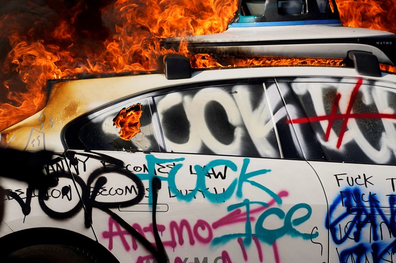 USA-MIGRATION/PROTEST-LOS ANGELES SENSITIVE MATERIAL. THIS IMAGE MAY OFFEND OR DISTURB Waymo cars burn during a protest against federal immigration sweeps in downtown Los Angeles, California, U.S. June 8, 2025. REUTERS/Daniel Cole TPX IMAGES OF THE DAY