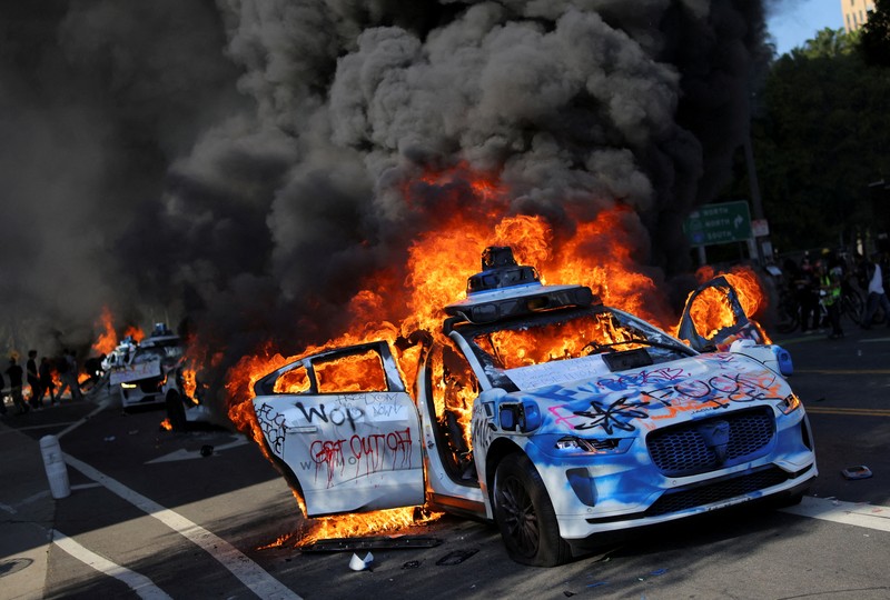 SENSITIVE MATERIAL. THIS IMAGE MAY OFFEND OR DISTURB   Waymo cars burn during a protest against federal immigration sweeps in downtown Los Angeles, California, U.S. June 8, 2025. REUTERS/Daniel Cole     TPX IMAGES OF THE DAY
