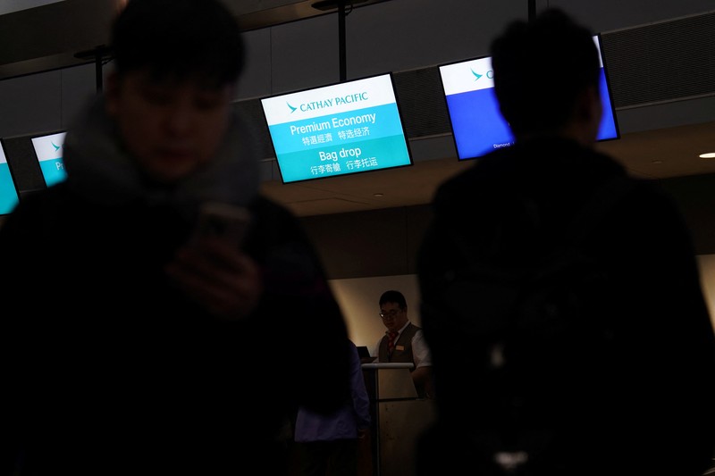 A traveler waits for his vehicle at an Uber passenger pick-up area at Terminal 8 at John F. Kennedy International Airport, ahead of U.S. President Donald Trump?s reinstatement of a new travel ban barring citizens of 12 countries from entering the U.S., in New York, U.S., June 8, 2025. REUTERS/Bing Guan