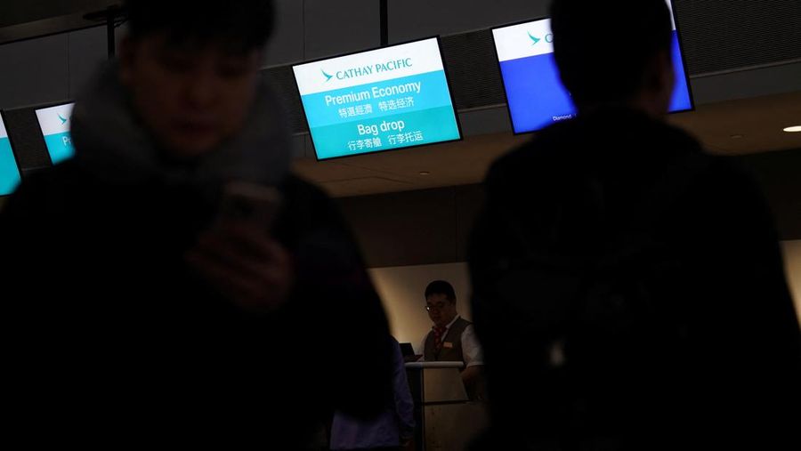 A traveler waits for his vehicle at an Uber passenger pick-up area at Terminal 8 at John F. Kennedy International Airport, ahead of U.S. President Donald Trump?s reinstatement of a new travel ban barring citizens of 12 countries from entering the U.S., in New York, U.S., June 8, 2025. REUTERS/Bing Guan