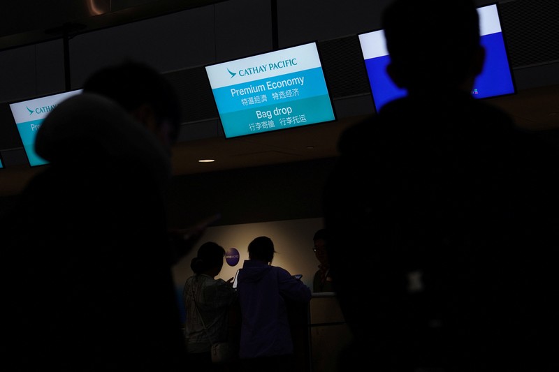 A traveler waits for his vehicle at an Uber passenger pick-up area at Terminal 8 at John F. Kennedy International Airport, ahead of U.S. President Donald Trump?s reinstatement of a new travel ban barring citizens of 12 countries from entering the U.S., in New York, U.S., June 8, 2025. REUTERS/Bing Guan