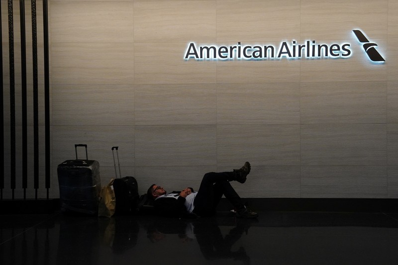 A traveler waits for his vehicle at an Uber passenger pick-up area at Terminal 8 at John F. Kennedy International Airport, ahead of U.S. President Donald Trump?s reinstatement of a new travel ban barring citizens of 12 countries from entering the U.S., in New York, U.S., June 8, 2025. REUTERS/Bing Guan