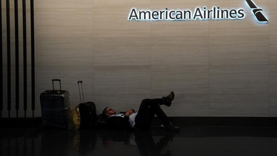 USA-TRAVEL/ A traveler waits for his vehicle at an Uber passenger pick-up area at Terminal 8 at John F. Kennedy International Airport, ahead of U.S. President Donald Trump?s reinstatement of a new travel ban barring citizens of 12 countries from entering the U.S., in New York, U.S., June 8, 2025. REUTERS/Bing Guan