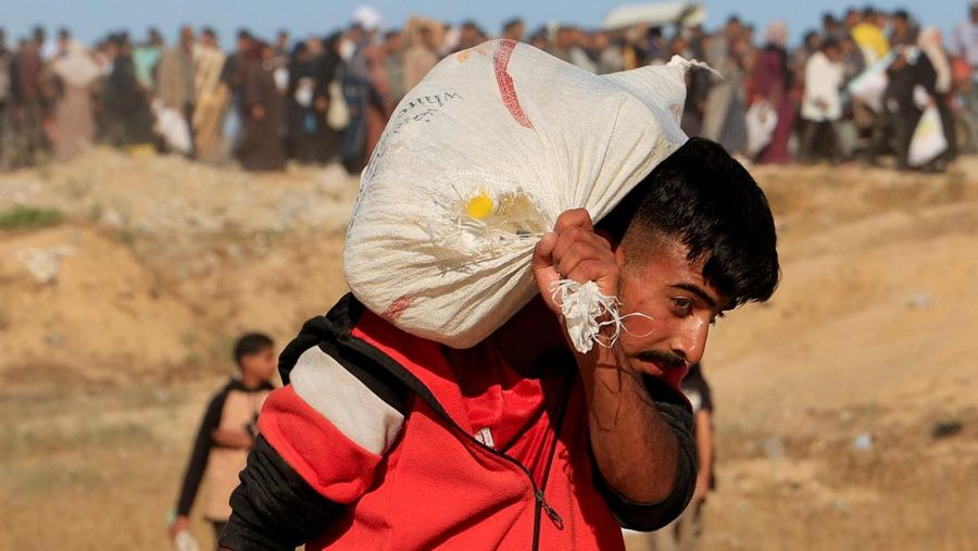 Ratusan warga Palestina berlarian saat mereka bergegas memasuki lokasi bantuan yang dikelola oleh Yayasan Kemanusiaan Gaza (GHF) di Jalur Gaza (12/6/2025). (Istimewa)