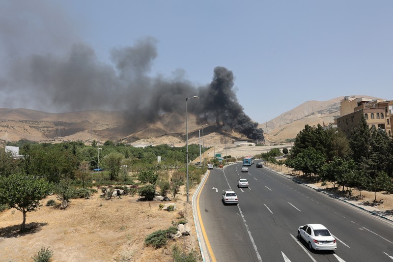 Asap mengepul menyusul apa yang dikatakan Iran sebagai serangan Israel terhadap depot minyak Sharan di Teheran, Iran, Senin (16/6/2025). (Majid Asgaripour/WANA via REUTERS)
