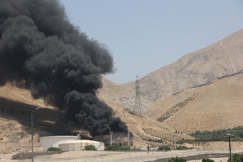 Asap mengepul menyusul apa yang dikatakan Iran sebagai serangan Israel terhadap depot minyak Sharan di Teheran, Iran, Senin (16/6/2025). (Majid Asgaripour/WANA via REUTERS)