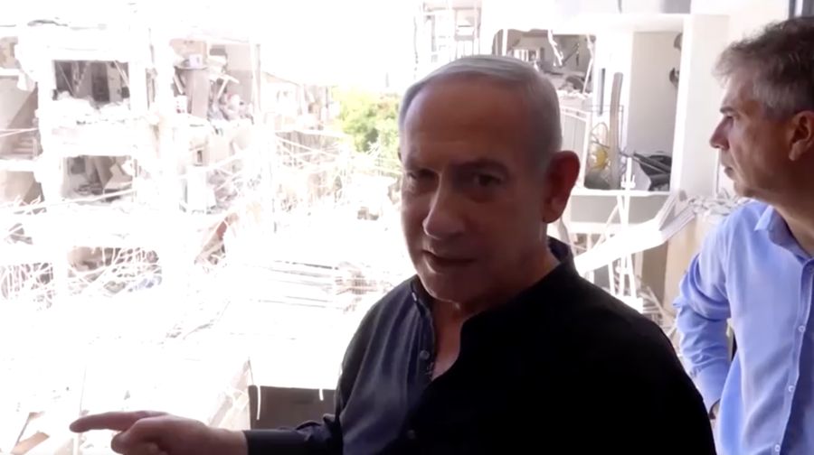 Perdana Menteri Israel Benjamin Netanyahu mengunjungi lokasi daerah permukiman yang hancur akibat serangan rudal Iran di dekat Tel Aviv, Israel, Minggu (15/6/2025). (Tangkapan Layar Video/REUTERS)