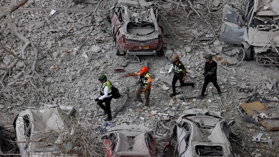 Emergency personnel work amid debris at an impacted residential site, following a missile attack from Iran on Israel, amid the Israel-Iran conflict, in Be'er Sheva, Israel June 24, 2025. REUTERS/Amir Cohen