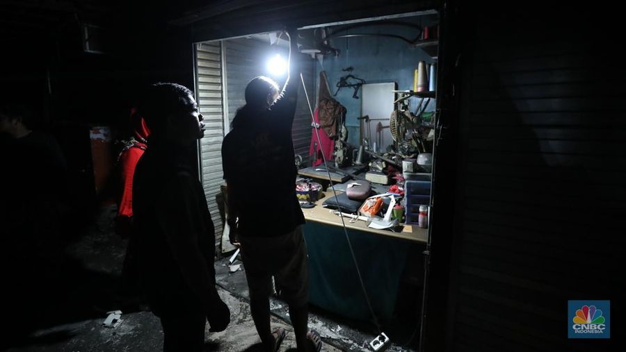 Sejumlah pedagang memeriksa sisa-sisa barang yang masih bisa digunakan setelah kebakaran melanda Pasar Kebon Kembang, Bogor, Jawa Barat, Rabu (25/6/2025). (CNBC Indonesia/Tri Susilo)