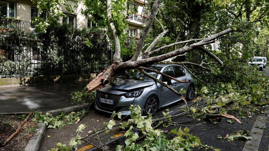 Pemandangan cabang-cabang pohon yang patah di atas mobil yang rusak di jalan sehari setelah badai besar melanda Paris, Prancis, 26 Juni 2025. REUTERS/Benoit Tessier