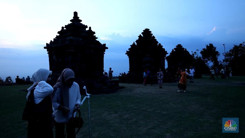 Sejumlah pengunjung mengabadikan situs warisan budaya Jogja di kawasan Dusun Groyokan, Desa Sambirejo, Kecamatan Prambanan, Kabupaten Sleman, Daerah Istimewa Yogyakarta, Jumat (27/6/2025). (CNBC Indonesia/Tri Susilo)