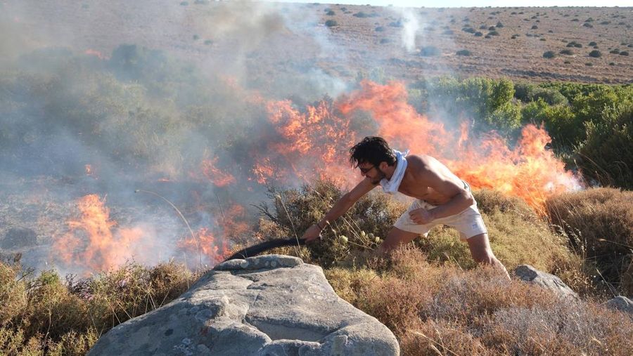 Seorang wanita bereaksi saat mencoba meninggalkan daerah tersebut dengan skuternya, selama kebakaran hutan di dekat Alacati, di provinsi Izmir, Turki, 3 Juli 2025. (REUTERS/Murat Kocabas)