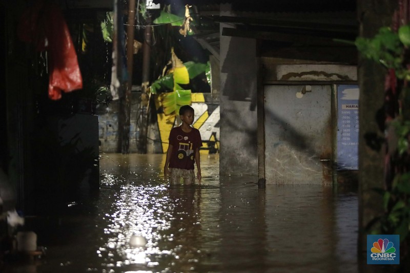 Sejumlah warga melintas di tengah banjir di RW 06 Jatipadang, Jakarta Selatan, (6/7/2025). Sejumlah warga melintas di tengah banjir di RW 06 Jatipadang, Jakarta Selatan, (6/7/2025). (CNBC Indonesia/Muhammad Sabki)