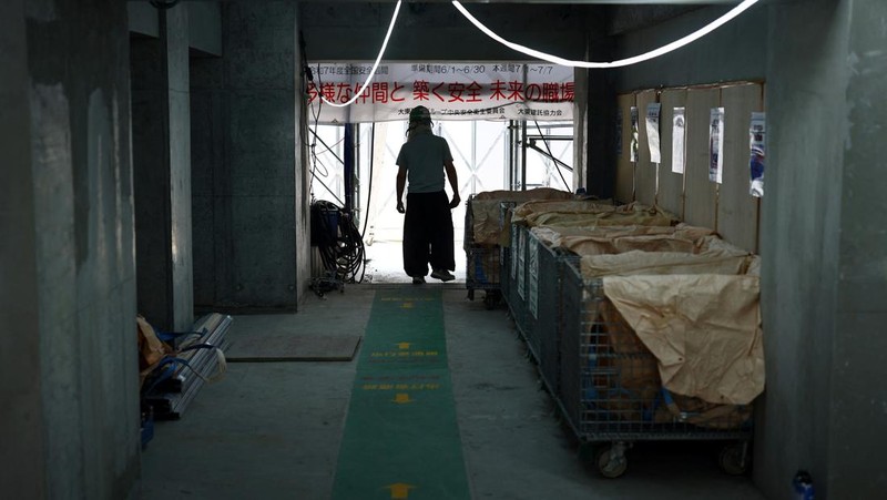 Heat-exposed workers, wearing air-conditioned jackets, which have cooling fans on their backs, are seen at the top of an apartment building under construction, as the Japanese government issued a heatstroke alert in Tokyo and other prefectures, in Tokyo, Japan, July 7, 2025. REUTERS/Issei Kato