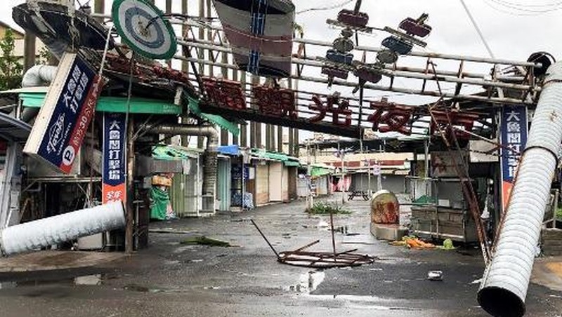 This picture shows the collapsed archway of Nankunshen Daitian temple and the flooded courtyard in the aftermath of Typhoon Danas in Tainan on July 7, 2025. Typhoon Danas made landfall on the west coast of Taiwan late on July 6, the Central Weather Administration said, dumping torrential rain on the island that triggered flooding and landslides. (Photo by Johnson LIU / AFP)