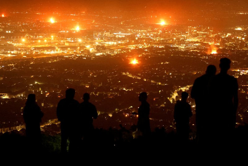MIGRATION-NIRELAND/ A loyalist bonfire burns after being set alight, featuring a model effigy of a boat containing mannequins portrayed as migrants in lifejackets, with a sign reading