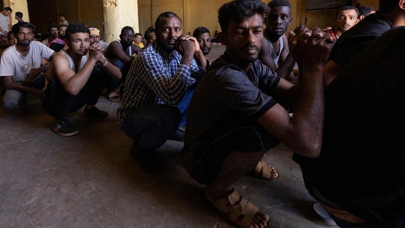 A group of newly-arrived migrants board a ferry bound for Piraeus, mainland Greece, in Souda, on the island of Crete, Greece, July 11, 2025. REUTERS/Nicolas Economou