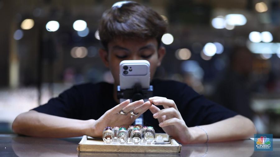 Pedagang memasarkan batu cicin secara daring di Pasar Rawa Bening, Jakarta, Senin (14/7/2025). (CNBC Indonesia/Tri Susilo) Pedagang memasarkan batu cicin secara daring di Pasar Rawa Bening, Jakarta, Senin (14/7/2025). (CNBC Indonesia/Tri Susilo)
