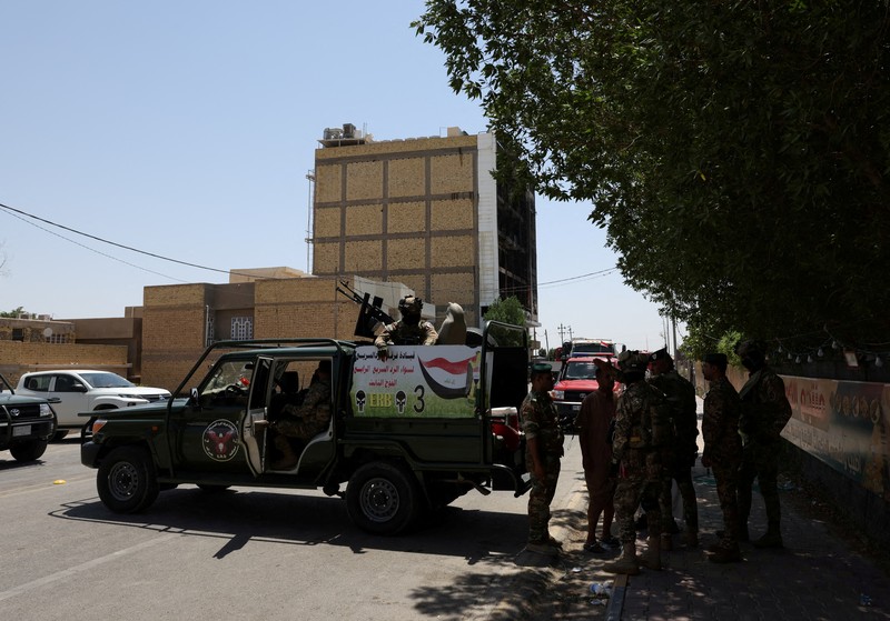 Truk pemadam kebakaran berdiri di samping reruntuhan pusat perbelanjaan, setelah kebakaran besar semalam yang menewaskan puluhan orang, di al-Kut, provinsi Wasit, Irak, 17 Juli 2025. Truk pemadam kebakaran berdiri di samping reruntuhan pusat perbelanjaan, setelah kebakaran besar semalam yang menewaskan puluhan orang, di al-Kut, provinsi Wasit, Irak, 17 Juli 2025. (REUTERS/Ahmed Saad)