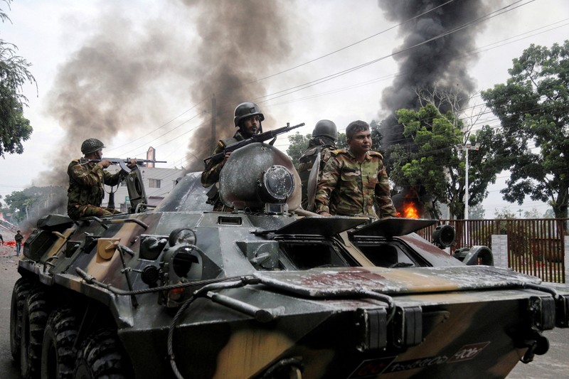 BANGLADESH-VIOLENCE/ Soldiers sit atop an APC after armed forces were deployed, following a clash during a National Citizen Party rally, in Gopalganj, Bangladesh, July 16, 2025. REUTERS/Anik Rahman
