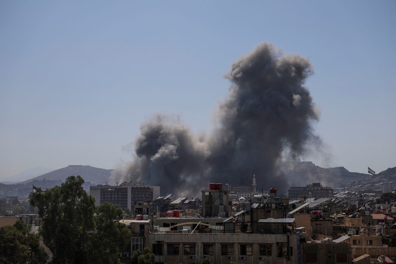 Smoke rises after Israeli strikes on Syria's defense ministry in Damascus, according to Al Jazeera TV, in Damascus, Syria July 16, 2025. REUTERS/Khalil Ashawi