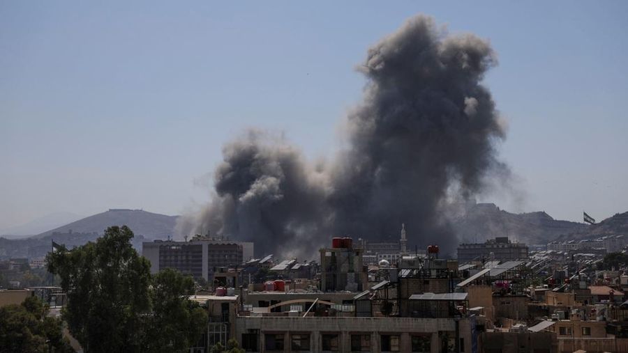 Smoke rises after Israeli strikes on Syria's defense ministry in Damascus, according to Al Jazeera TV, in Damascus, Syria July 16, 2025. REUTERS/Khalil Ashawi