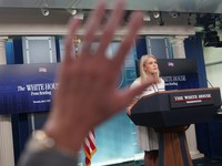 A hand is raised as White House Press Secretary Karoline Leavitt speaks during a press briefing at the White House in Washington, D.C., U.S., July 17, 2025. REUTERS/Nathan Howard